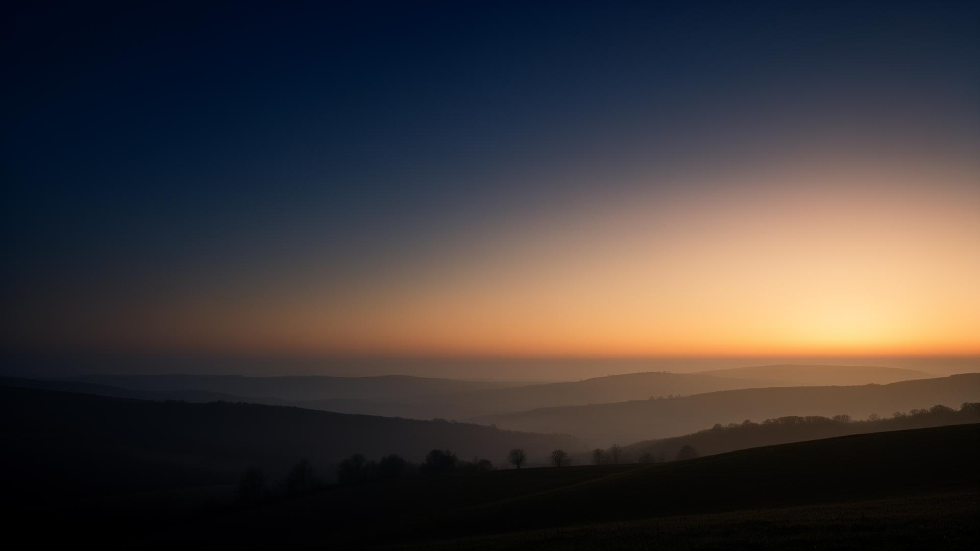 Soft horizon at dawn — calm landscape with warm light over rolling hills